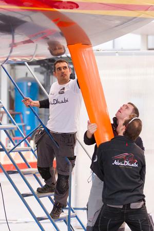 24th February 2014. ENGLAND, Hythe, Green Marine. Tom Bushell and Ben Davis fit one of Abu Dhabi Ocean Racing's rudders. photo copyright  Ian Roman / Abu Dhabi Ocean Racing taken at  and featuring the  class