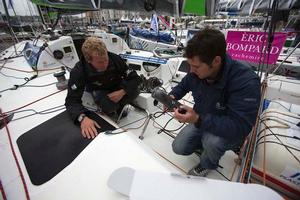 Skipper Ed Hill talks British prÃ©parateur Aaron Cooper through the repairs needed on his boat. photo copyright Ocean Images taken at  and featuring the  class