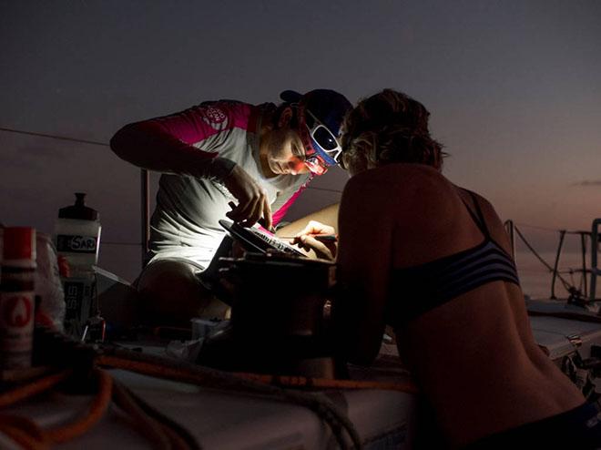 Leg 3 onboard Team SCA. Day 12. Sara Hasreiter and Abby Ehler fix the starboard primary winch shortly after sunset. © Corinna Halloran - Volvo Ocean Race http://www.volvooceanrace.com