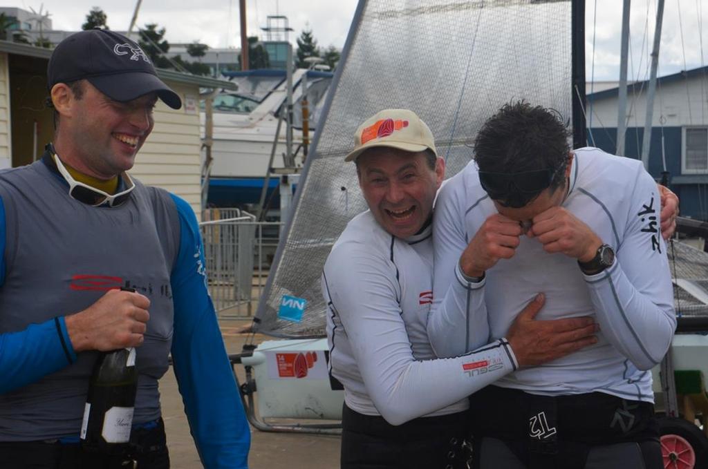 The newest I14 World Champions, Britain’s Sam Pascoe and Glen Truswell, celebrate while defending World Champion Archie Massey jokingly sheds tears over his title loss - 2015 International 14 World Championship. © Rhenny Cunningham