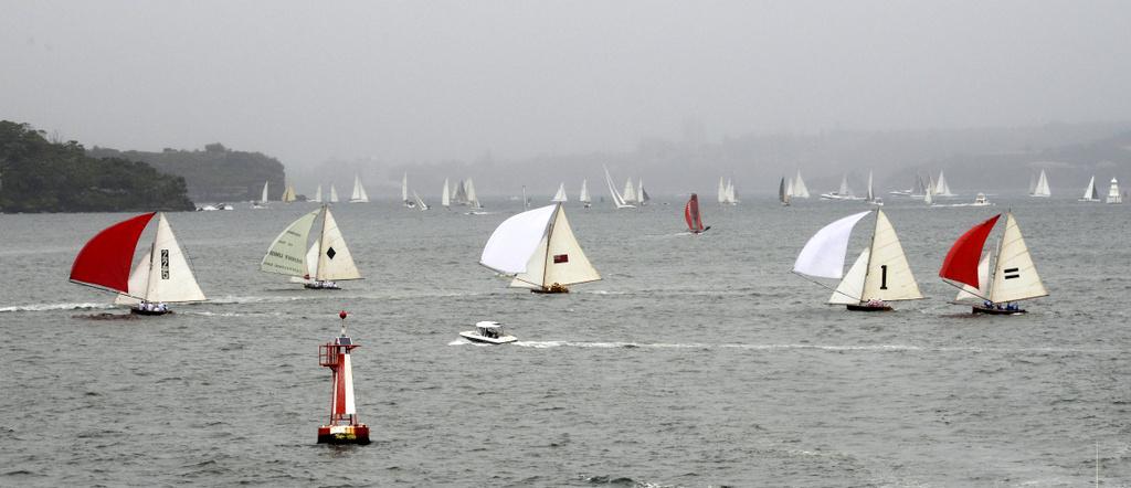 Gloomy day on Sydney Harbour with historical skiffs in foreground…mist in the back - Australia Day Regatta 2015 photo copyright John Jeremy http://www.sasc.com.au taken at  and featuring the  class