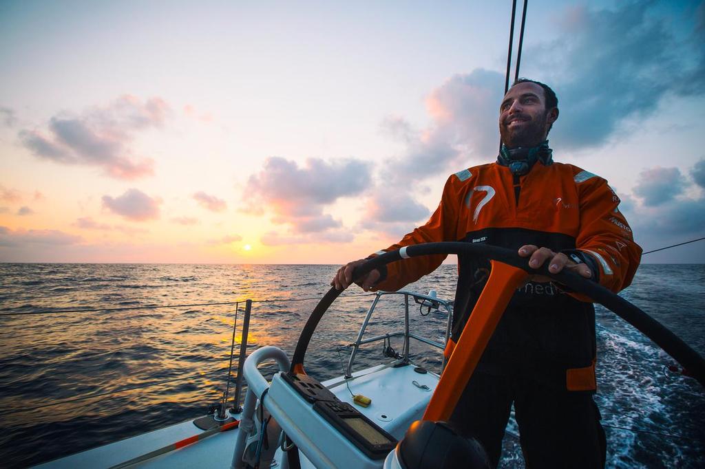 January 27, 2015. Day 24 of Leg 3 to Sanya, onboard Team Alvimedica. The final 50 miles to Sanya are spent in a building breeze at sunrise with MAPFRE and Brunel in hot pursuit, just 8 miles astern. Seb Marsset on the helm at sunrise. ©  Amory Ross / Team Alvimedica