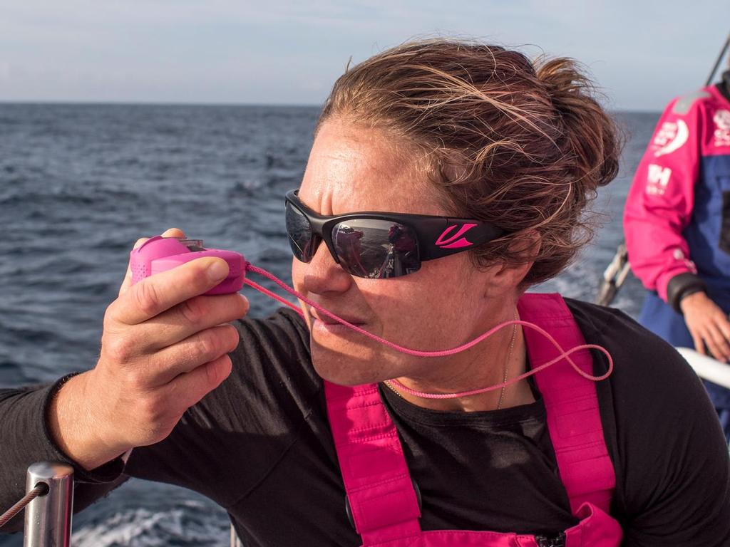 October 14, 2014. Leg 1 onboard Team SCA. Sally Barkow takes a bearing on the other teams during the evening hours of Tuesday. photo copyright Corinna Halloran / Team SCA taken at  and featuring the  class