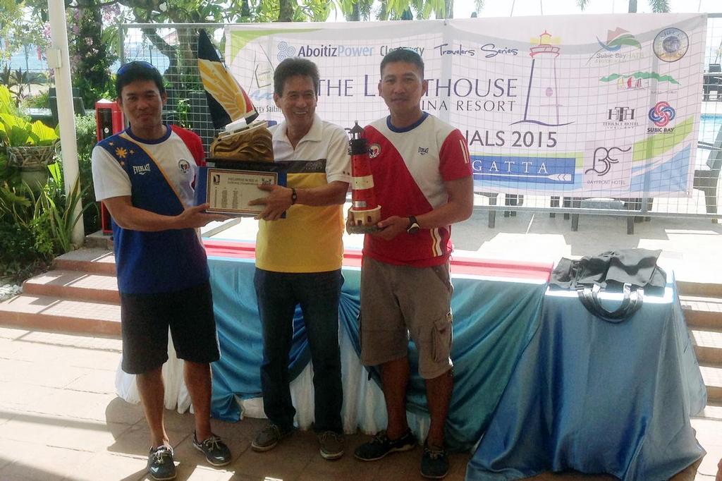Ridgely Balladares and Richly Magsanay with the perpetual trophy and championship trophy from Lighthouse Marina's Jun Avecilla © Rico Santos