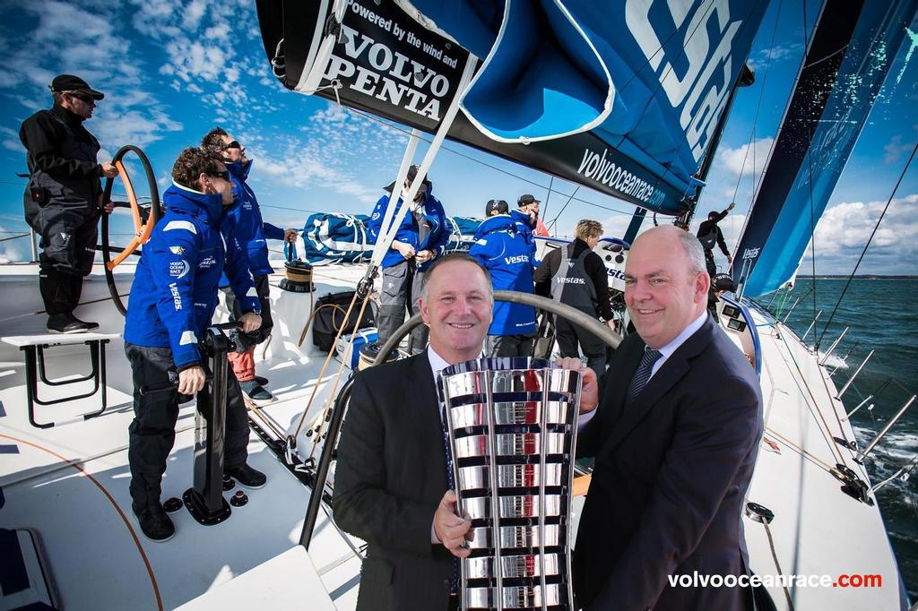 27 February, 2015. Volvo Ocean Race Village opening in Auckland. John Key - Prime Minister of New Zealand and Steven Joyce - Minister for Economic Development taking a shot with the Trophy in the Tap-Snap activity. Volvo Ocean Race 2014-15 ©  Ainhoa Sanchez/Volvo Ocean Race