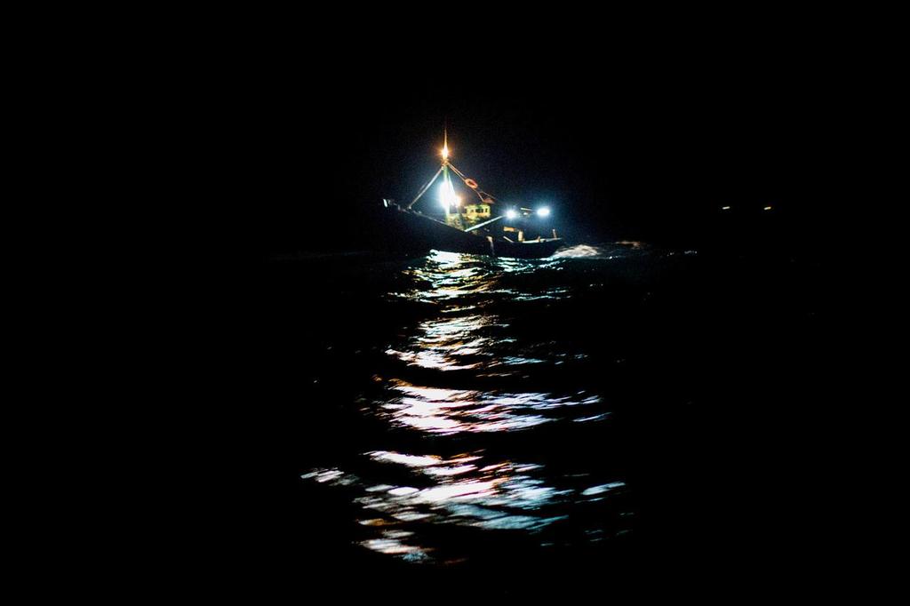 January 24, 2015. Day 21 of Leg 3 to Sanya, onboard Team Alvimedica.  The upwind conditions continue in the gut of the South China Sea, 100 miles south of the Vietnam Coast. A well lit fishing boat off the Vietnamese coast. photo copyright  Amory Ross / Team Alvimedica taken at  and featuring the  class