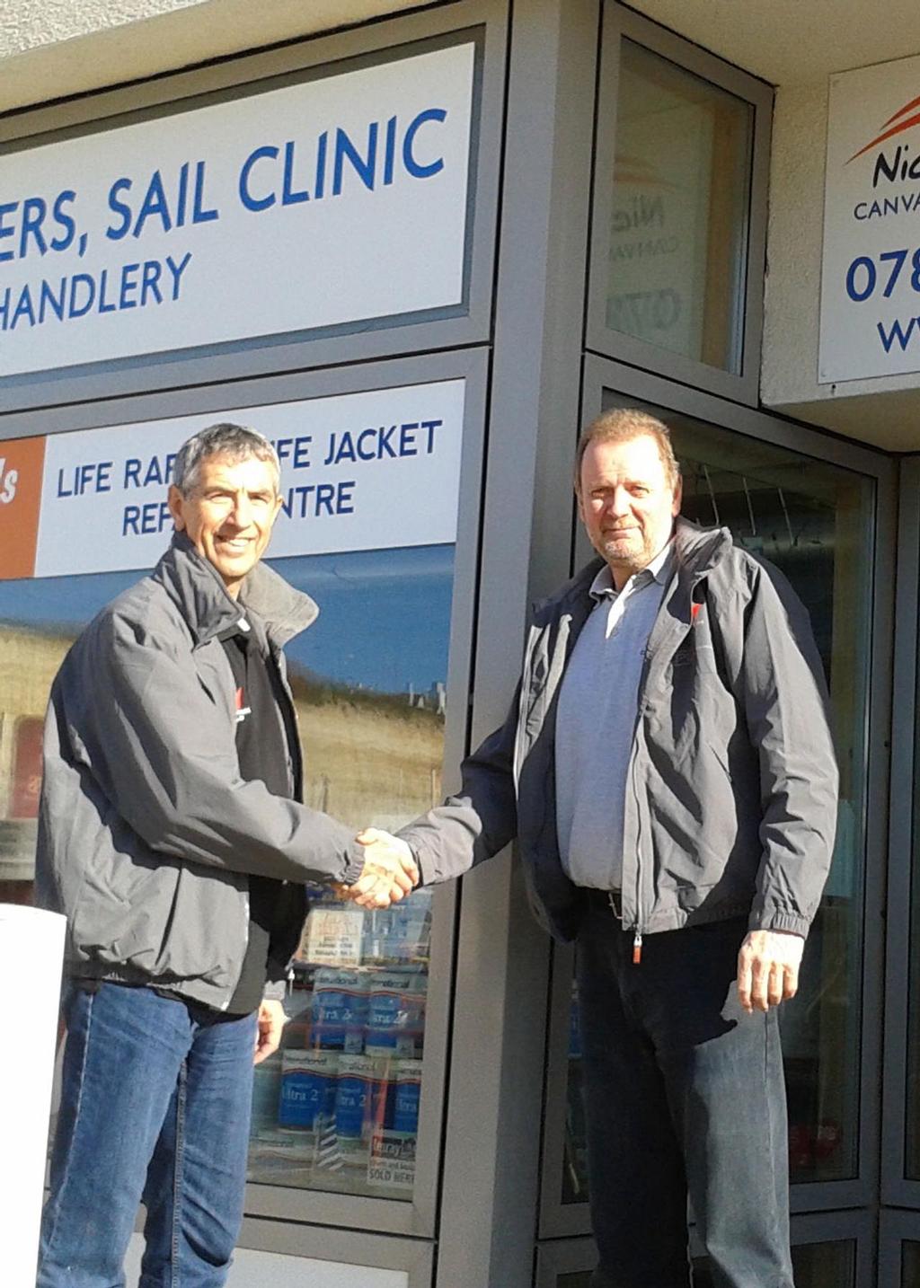 Dave Richards, sail consultant at Elvstrom Sails UK seals the deal with Phil Godfrey of Nickys Canvasworks and Sail Clinic in Brighton photo copyright Liz Rushall taken at  and featuring the  class