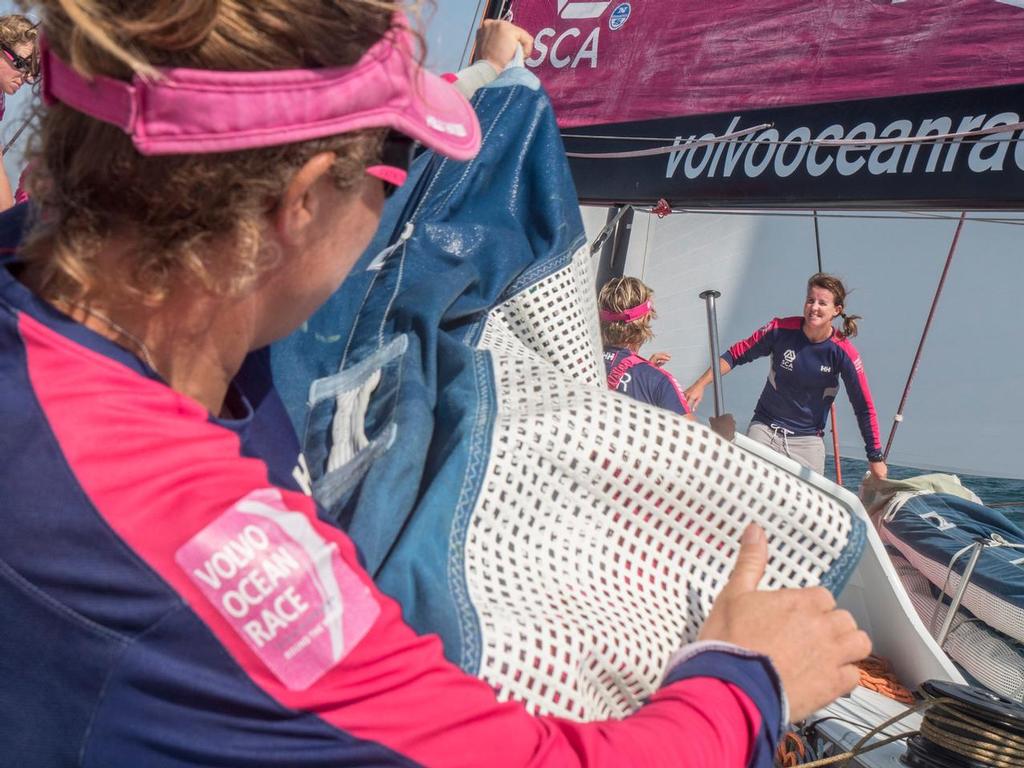 January 6, 2015. Leg 3 onboard Team SCA. Sally Barkow helps lift the stack during a gybe. © Corinna Halloran / Team SCA