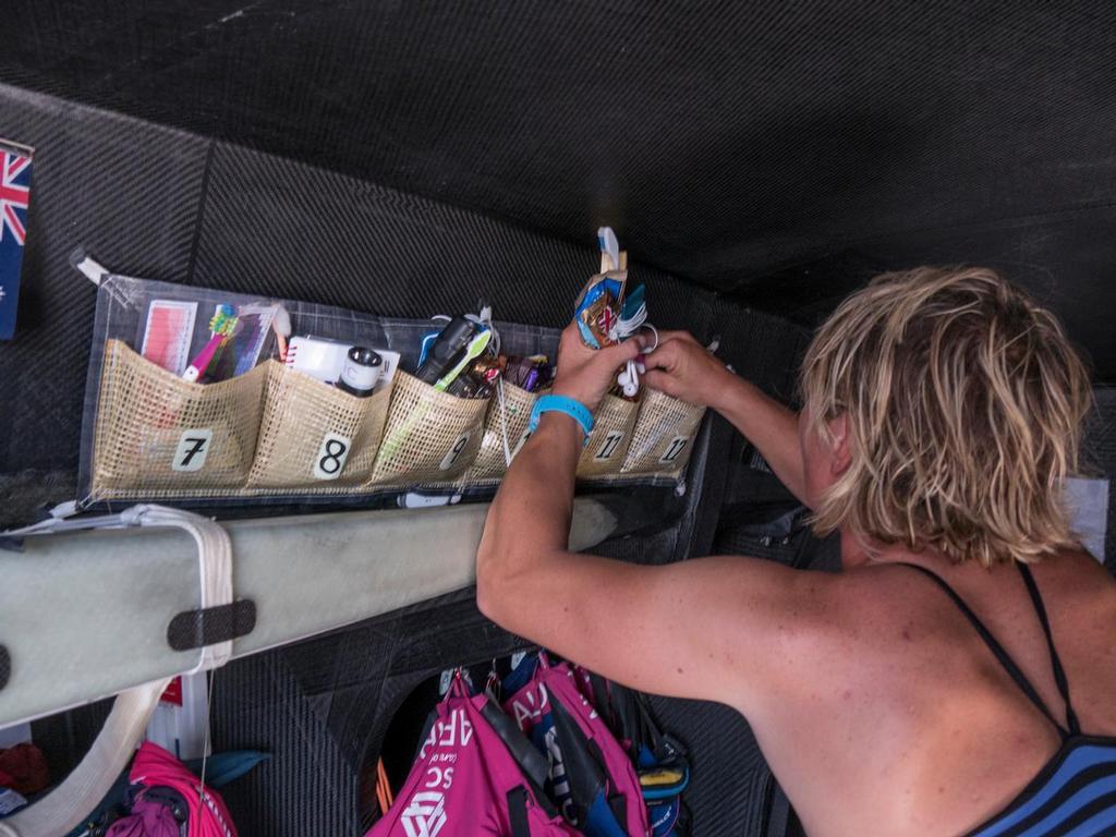 January 14, 2015. Leg 3 onboard Team SCA. Day 11. Annie Lush has way too much chocolate; Abby Ehler has a difficult time putting Annie's life pocket back in order because of all the chocolate still in there. © Corinna Halloran / Team SCA