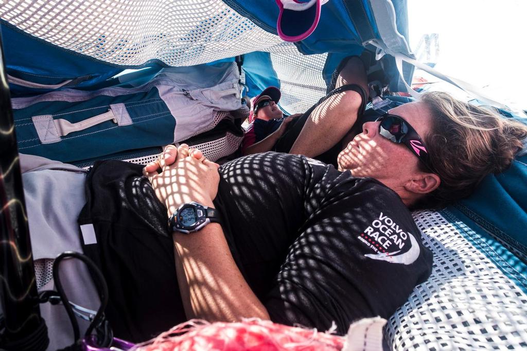 February 23, 2015. Leg 4 to Auckland onboard Team SCA.  Day 15. Sally Barkow and Stacey Jackson hiding from the sun on the bow in a sail bag tent. © Anna-Lena Elled/Team SCA