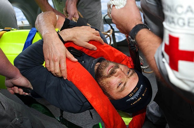 Injured French solo yachtsman, Yann Elies is carried along the starboard waist on a stretcher by members of the ship’s company of HMAS Arunta, after being transferred from the rigid hull inflatable boat (RHIB) and on to the ship. Photography by Able Seaman Photographer Lincoln Commane.<br />
 © Commonwealth of Australia