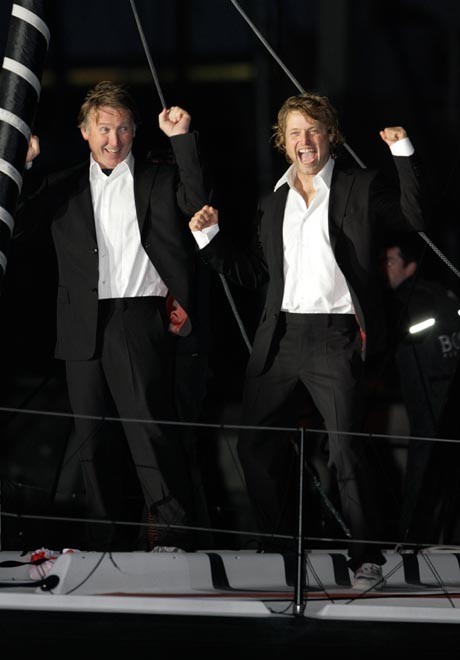 Alex and Andrew celebrating on the bow of Hugo Boss (Copyright onEdition/Barcelona World Race © onEdition http://www.onEdition.com