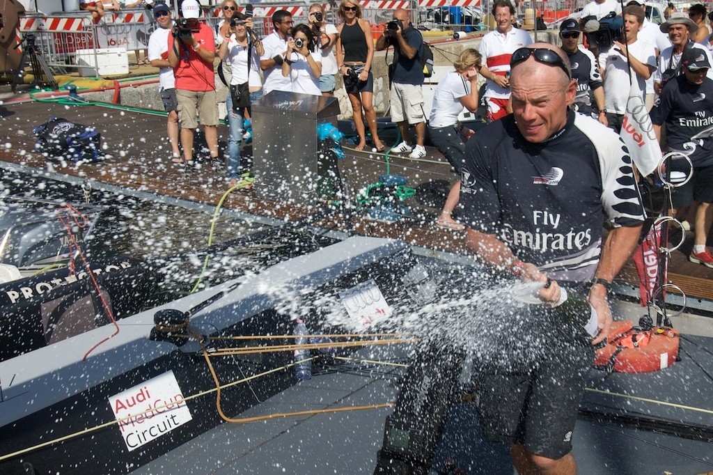 Emirates Team New Zealand CEO Grant Dalton sprays Champagne at the crew of NZL380 after the team win the Sardinia Trophy, Audi MedCup © Emirates Team New Zealand / Photo Chris Cameron ETNZ 