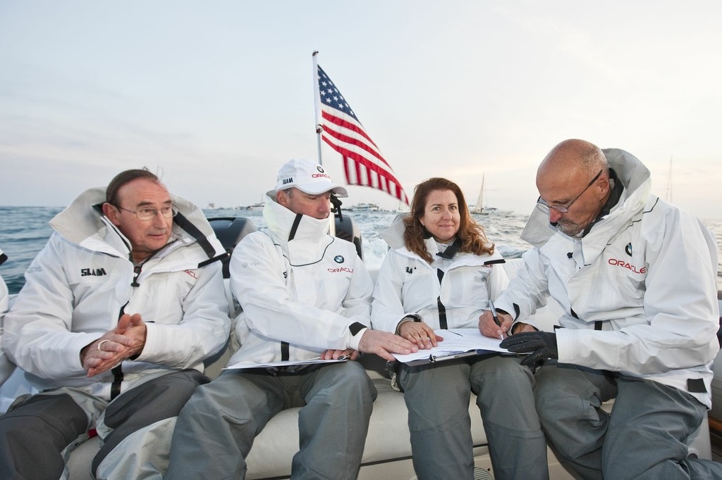 BMW ORACLE Racing - Race 2 - As USA crosses the finish Line, GGYC accept the Club Nautico di Roma as challenger of Record , l. to r. :  Melinda Erkelens (GGYC) - Norbert Barjurin (GGYC) - Marcus Young (GGYC)  - Alessandra Pandarese (Club Nautico di Roma)- Vincenzo Onorato (Club Nautico di Roma) as USA crosses the finish Line, GGYC accept the Club Nautico di Roma © BMW Oracle Racing Photo Gilles Martin-Raget http://www.bmworacleracing.com