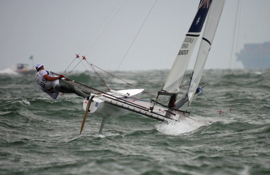 Darren Bundock and Glenn Ashby (now with Emirates Team NZ) blast up the beat in the Medal Race of the 2008 Olympic Regatta in strong winds, a heavy, breaking cross sea and driving rain, to win the Silver medal in the Tornado multihull event.  Yachting NZ had a selection criteria that sailors must have proven performance in light weather. The 2008 Olympics was widely regarded as the heaviest air since 1988 in Korea. © Richard Gladwell www.photosport.co.nz