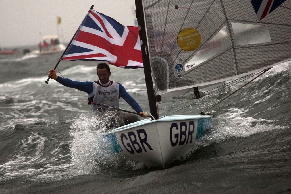 Ben Anslie (GBR) Gold Medal holding the British flag after winning the Finn Gold medal at the 2008 Olympics. photo copyright Guy Nowell http://www.guynowell.com taken at  and featuring the  class