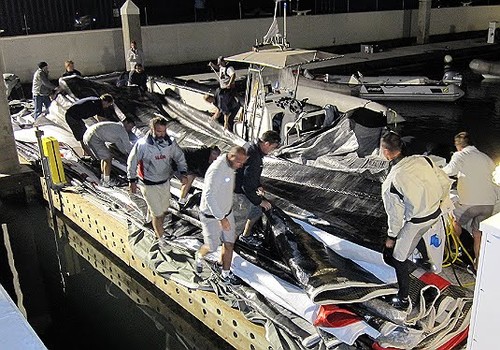 BOR90’s sails are sorted on the dock after the dismasting by Peter Rusch © BMW Oracle Racing http://bmworacleracing.com