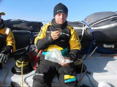 Helmsman Rob Greenhalgh tucks into a snack on deck of Volvo Open 70 ABN AMRO ONE on Day 3 of Leg 4 in the Volvo Ocean Race 2005-6. © Volvo Ocean Race http://www.volvooceanrace.com