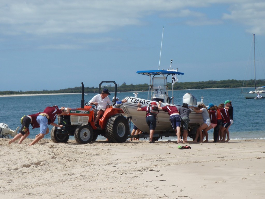 The Queensland Team all pulled together to help launch their coach, Adrian Finglass’s boat across the soft sand. - 2011 Australian Laser Championship © ALCA Media