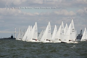 The 35 boat J24 fleet starts in front of the Chesapeake Bay Bridge and a looming Navy battleship and submarine. - J24 East Coast Championship photo copyright Tim Wilkes taken at  and featuring the  class