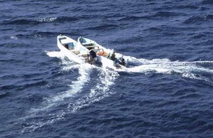 Pirates boats are seen nearby the Chinese ship ``Zhenhua 4`` in the Gulf of Aden, December 17, 2008 in this handout photo. The Chinese ship escaped pirate hijack in the Gulf of Aden after the crew fought for four hours with the help of a multi-coalition force. Nine pirates armed with rocket launchers and heavy machine guns boarded the ship. The 30 crew members locked themselves in their accommodation area, using fire hydrants and firebombs to prevent the attackers from entering, said an official w photo copyright SW taken at  and featuring the  class