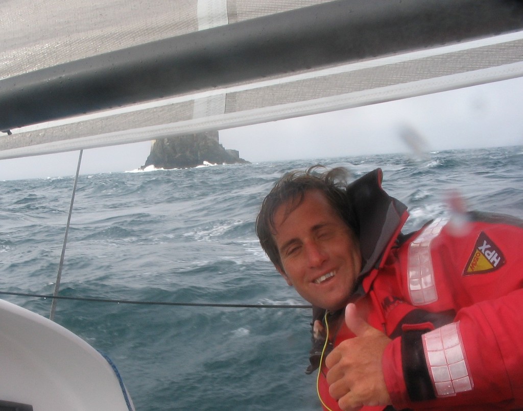 scott gives the thumps up on rounding Fastnet Rock - Uk mini fastnet Race photo copyright James Gair taken at  and featuring the  class