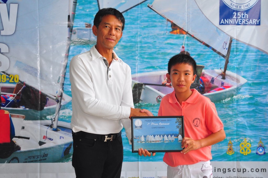 Vice Admiral Taratorn Kajitsuwan, Commander Third Naval Area Command, presenting winner of the Optimist Class in Series III, Anapat Ngarmdee. - Phuket King's Cup Regatta 2011 photo copyright Event Media taken at  and featuring the  class