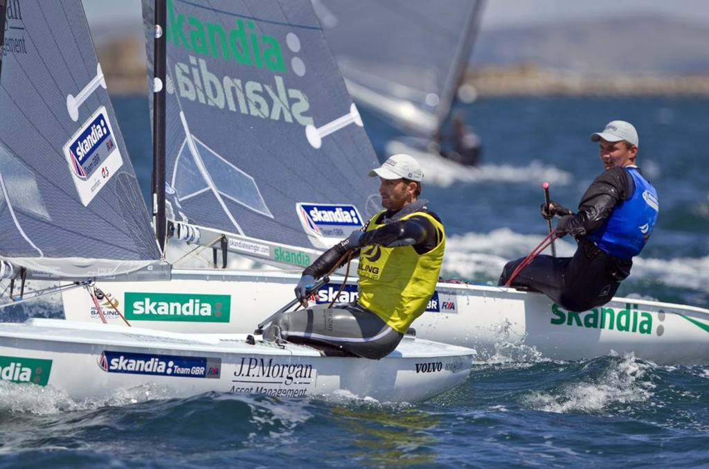 Ben Ainslie (left) from Great Britain on his way to winning the Gold Medal, battles with fellow Brit Giles Scott (right), in the Finn class on the medal day of the Skandia Sail for Gold Regatta, in Weymouth and Portland, the 2012 Olympic venue. © onEdition http://www.onEdition.com