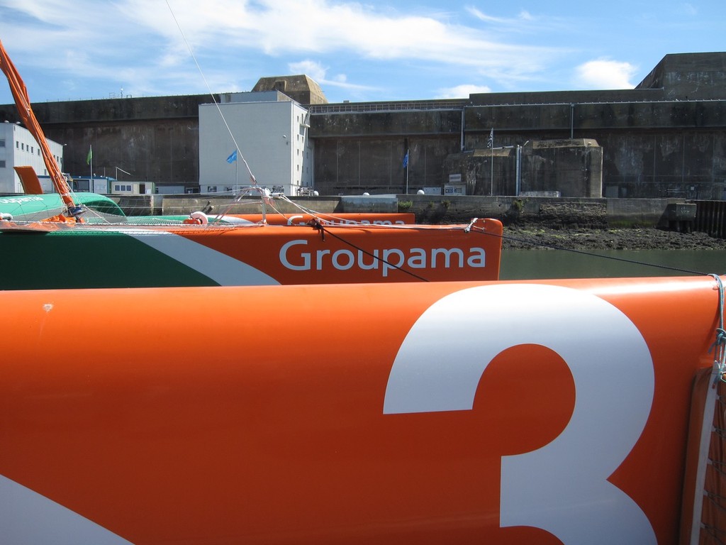 Groupama 3 with the submarine base in the background - Lorient, France photo copyright Ben Gladwell http://www.sail-world.com/nz taken at  and featuring the  class