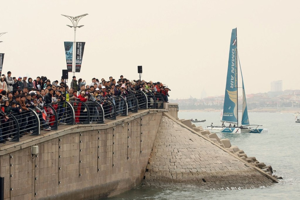 170411-QINGDAO-CHINA- Chinese crowds on 17 April, watch the EX40 catamarans sailing in Fusion Bay Qingdao, China, during the fleet racing format.  This is the 2nd leg of the 9 leg international Extreme Sailing Series. The event in Qingdao, Shandong Province, China, runs over five days April 13-17, 2011. Picture by Paul Lakatos/Oman Sail.
 - Extreme Sailing Series Act 2 final day photo copyright OmanSail  taken at  and featuring the  class