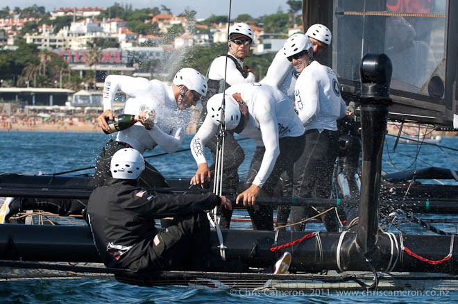 Oracle Racing helmsman James Spithill sprays his crew with champagne as he celebrates his winning the Match Racing 2-0 against Emirates Team New Zealand. Day six of the America’s Cup World Series, Cascais, Portugal. 13/8/2011 © Chris Cameron/ETNZ http://www.chriscameron.co.nz