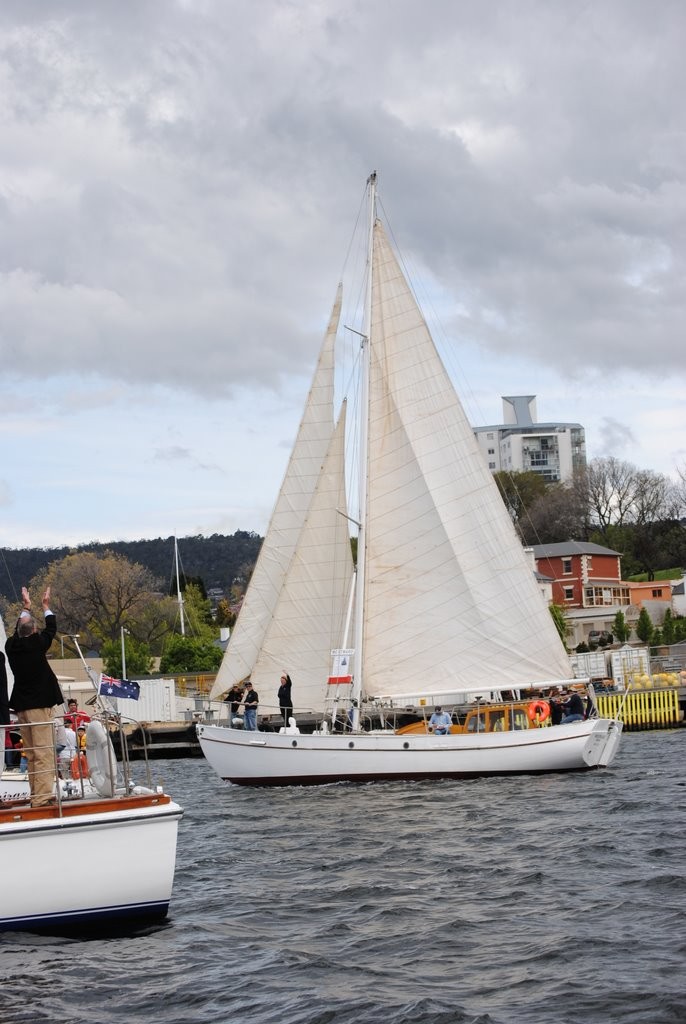 The 60 year old cutter Westward, winner of the 1947 and 1948 Sydney Hobart,  gets a wave from Tasmania’s Governor Peter Underwood AC, during the parade of sail that marked Opening Day on the River Derwent today photo copyright Rob Cruse taken at  and featuring the  class