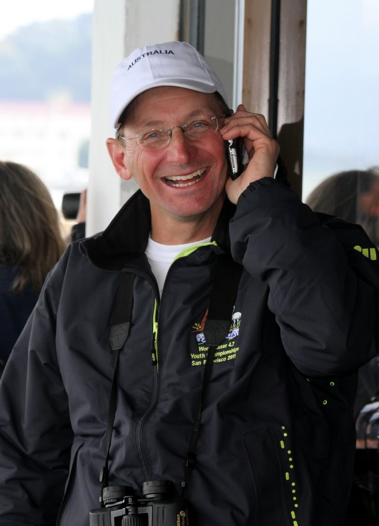 Anna’s excited father, Michael Vaughan, on the phone back to Hobart  - Laser 4.7 Championships 2011 photo copyright Richard Scarr taken at  and featuring the  class