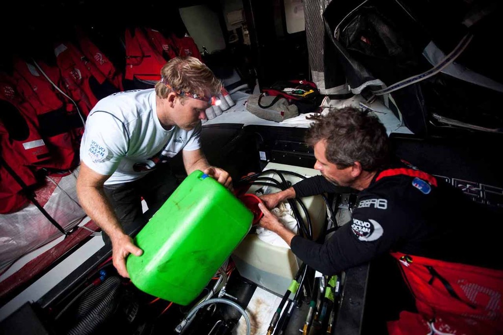 Casey Smith and Brad Jackson pour the diesel into several onboard fuel tanks. PUMA's ``Mar Mostro`` picking up diesel during a mid-ocean rendezvous with the ``Zim Monaco``. PUMA Ocean Racing powered by BERG during leg 1 of the Volvo Ocean Race 2011-12, from Alicante, Spain to Cape Town, South Africa. photo copyright Amory Ross/Puma Ocean Racing/Volvo Ocean Race http://www.puma.com/sailing taken at  and featuring the  class
