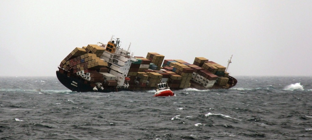  MV Rena grounded on Astrolabe Reef, Tauranga. She is beam on to four metre seas. The protruding section of the reef can be seen in the white water to the right of the shot photo copyright New Zealand Defence Force taken at  and featuring the  class