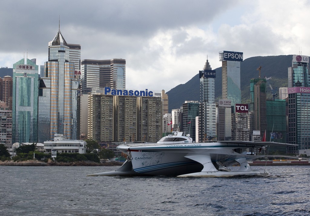 Old and new. TURANOR PlanetSolar salutes the Royal Hong Kong Yacht Club © Guy Nowell http://www.guynowell.com