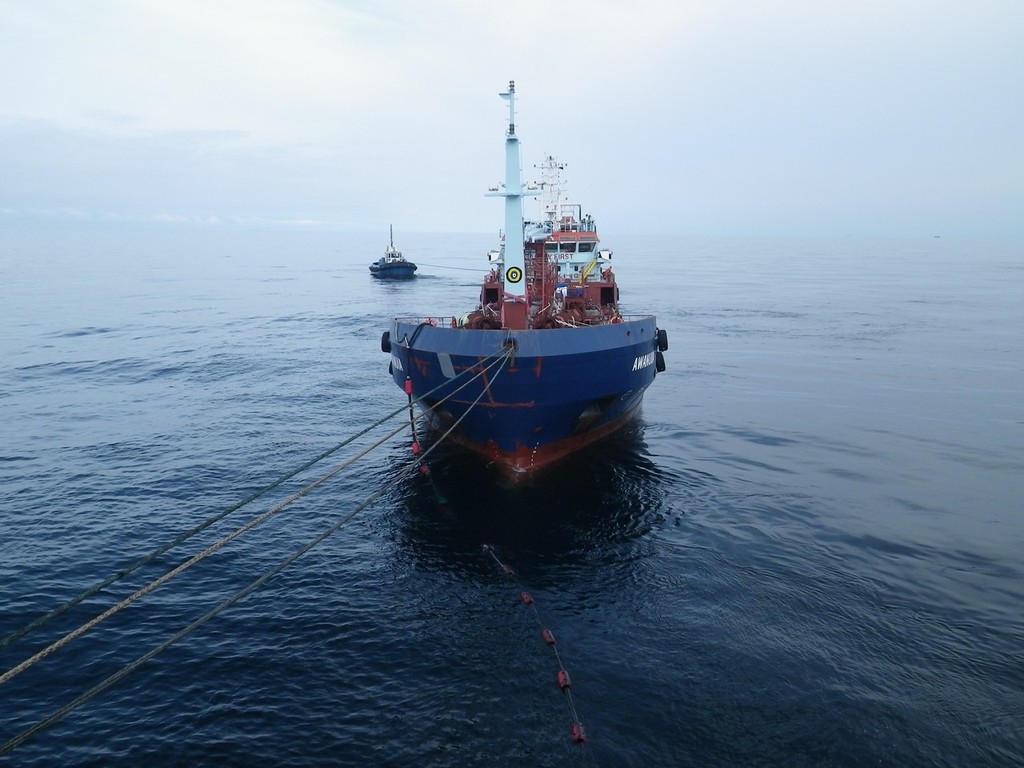 View from the Rena of the barge Awanuia. The fuel transfer hose (with red floats) to the Rena can be seen in the water.  © Maritime NZ www.maritimenz.govt.nz