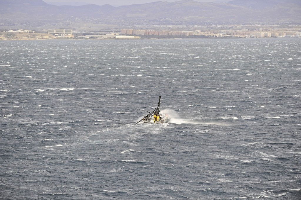 Abu Dhabi Ocean Racing's yacht Azzam, skippered by Britain's Ian Walker, returns to Alicante, Spain after the mast broke in rough weather on the first day of racing on leg 1 of the Volvo Ocean Race 2011-12. (Photo Credit must read: Paul Todd/Volvo Ocean Race) photo copyright Paul Todd/Volvo Ocean Race http://www.volvooceanrace.com taken at  and featuring the  class