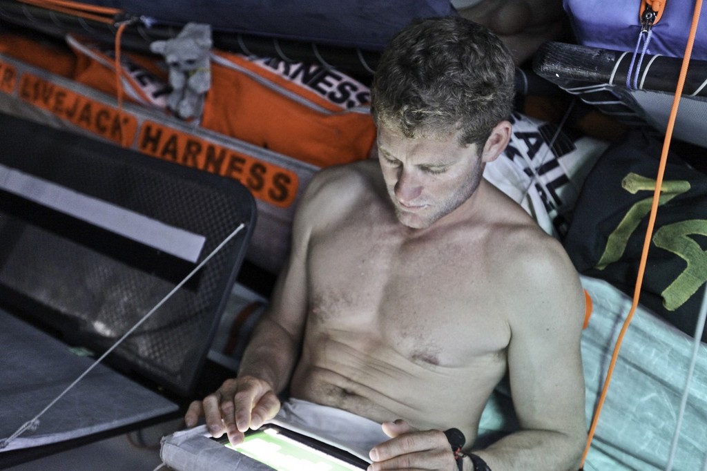Charles Caudrelier writing emails onboard Groupama Sailing Team during leg 1 of the Volvo Ocean Race 2011-12, from Alicante, Spain to Cape Town, South Africa. (Credit: Yann Riou/Groupama Sailing Team/Volvo Ocean Race) photo copyright Yann Riou/Groupama Sailing Team /Volvo Ocean Race http://www.cammas-groupama.com/ taken at  and featuring the  class
