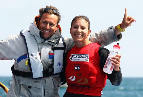 Bryony Shaw of Great Britain celebrates with her coach Dominic Tidey after winning a bronze medal in the RS-X Womens Class medal race on day ten of the Weymouth and Portland International Regatta 2011 ©  Clive Mason