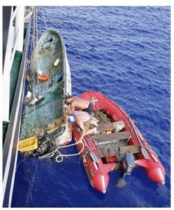 Tsunami debris being hoisted onto ship photo copyright  SW taken at  and featuring the  class