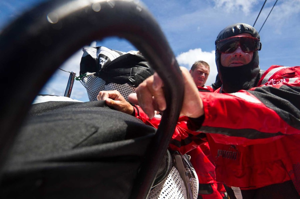 Jono Swain and Rome Kirby (background) take a momentary rest after moving the sail stack further back in the boat. PUMA Ocean Racing powered by BERG during leg 2 of the Volvo Ocean Race 2011-12, from Cape Town, South Africa to Abu Dhabi, UAE. (Credit: Amory Ross/PUMA Ocean Racing/Volvo Ocean Race) photo copyright Amory Ross/Puma Ocean Racing/Volvo Ocean Race http://www.puma.com/sailing taken at  and featuring the  class