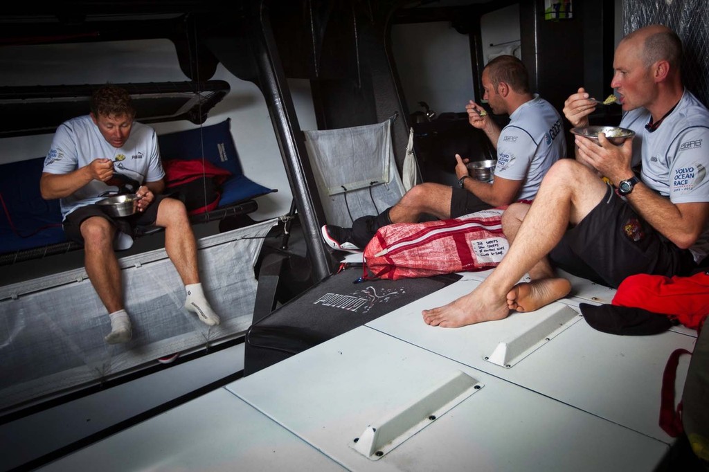 It's lunch time for Tom Addis, Ryan Godfrey, and Kelvin Harrap (L to R) onboard Puma's Mar Mostro. PUMA Ocean Racing powered by BERG during leg 2 of the Volvo Ocean Race 2011-12, from Cape Town, South Africa to Abu Dhabi, UAE. (Credit: Amory Ross/PUMA Ocean Racing/Volvo Ocean Race) photo copyright Amory Ross/Puma Ocean Racing/Volvo Ocean Race http://www.puma.com/sailing taken at  and featuring the  class