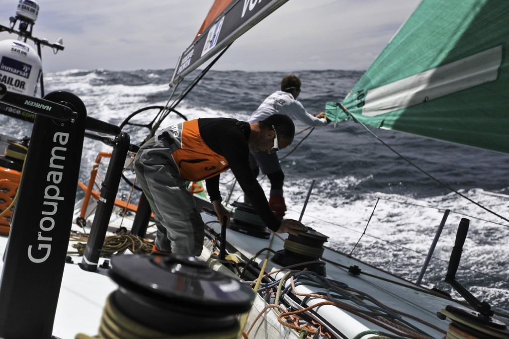 Damien Foxall from Ireland and Charles Caudrelier from France working on the sail onbard Groupama Sailing Team during leg 2 of the Volvo Ocean Race 2011-12, from Cape Town, South Africa to Abu Dhabi, UAE. (Credit: Yann Riou/Groupama Sailing Team/Volvo Ocean Race) photo copyright Yann Riou/Groupama Sailing Team /Volvo Ocean Race http://www.cammas-groupama.com/ taken at  and featuring the  class