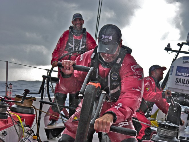 Rob Salthouse and Chris Nicholson grind hard as they put a reef in the mainsail as Stu Bannatyne drives onboard CAMPER with Emirates Team New Zealand during leg 3 of the Volvo Ocean Race 2011-12, from Abu Dhabi, UAE to Sanya, China.  © Hamish Hooper/Camper ETNZ/Volvo Ocean Race