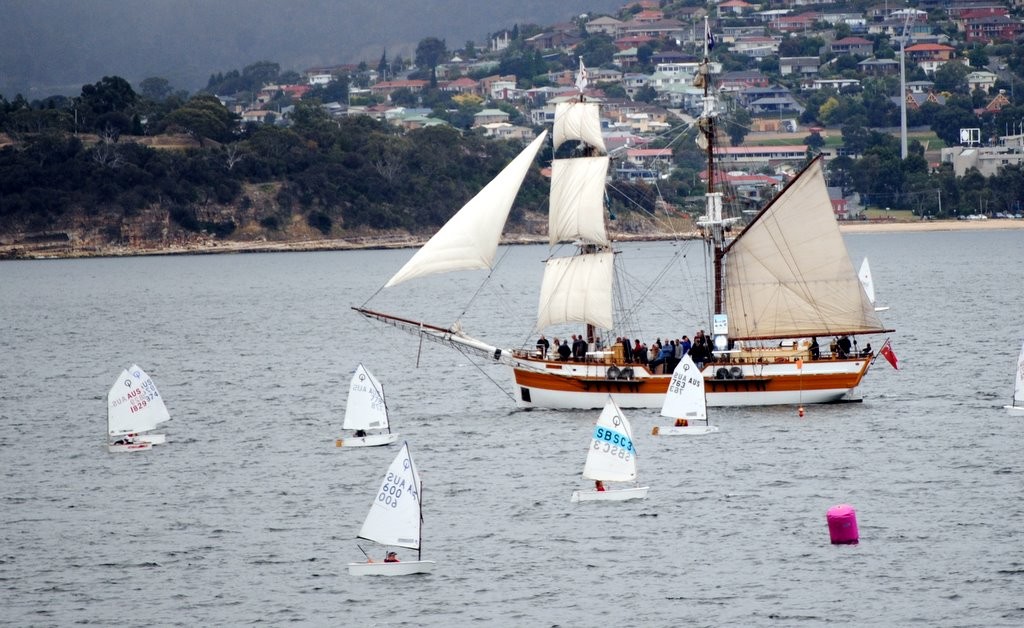 The Lady Nelson sails past the Optimist fleet on Hobart’s River Derwent - Optimist Tasmanian championship photo copyright  Andrea Francolini Photography http://www.afrancolini.com/ taken at  and featuring the  class