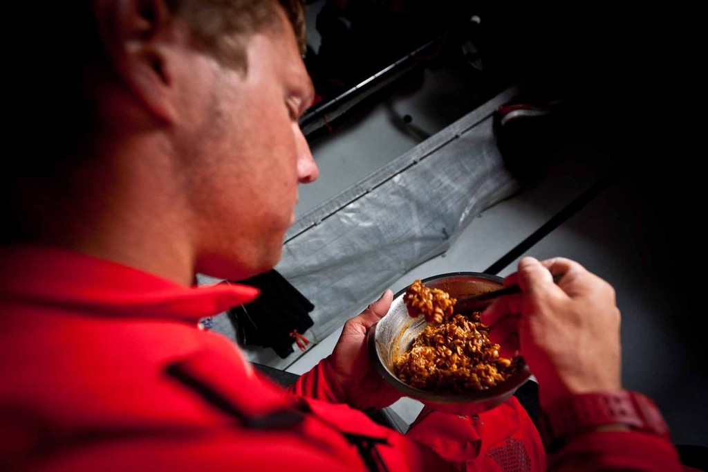 Rome Kirby mowing on some delicious Beef Rotini freeze-dried dinner. PUMA Ocean Racing powered by BERG during leg 4 of the Volvo Ocean Race 2011-12, from Sanya, China to Auckland, New Zealand. (Credit: Amory Ross/PUMA Ocean Racing/Volvo Ocean Race) photo copyright Amory Ross/Puma Ocean Racing/Volvo Ocean Race http://www.puma.com/sailing taken at  and featuring the  class