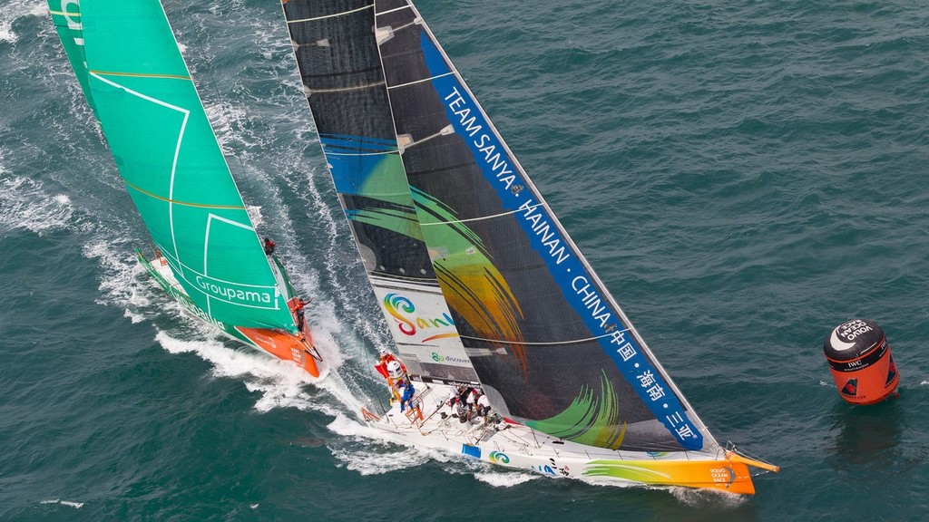 Team Sanya, skippered by Mike Sanderson from New Zealand leading Groupama Sailing Team, skippered by Franck Cammas from France into a mark rounding, in the Sanya Haitang Bay In-Port Race, during the Volvo Ocean Race 2011-12. (Credit: IAN ROMAN/Volvo Ocean Race) photo copyright Ian Roman/Volvo Ocean Race http://www.volvooceanrace.com taken at  and featuring the  class