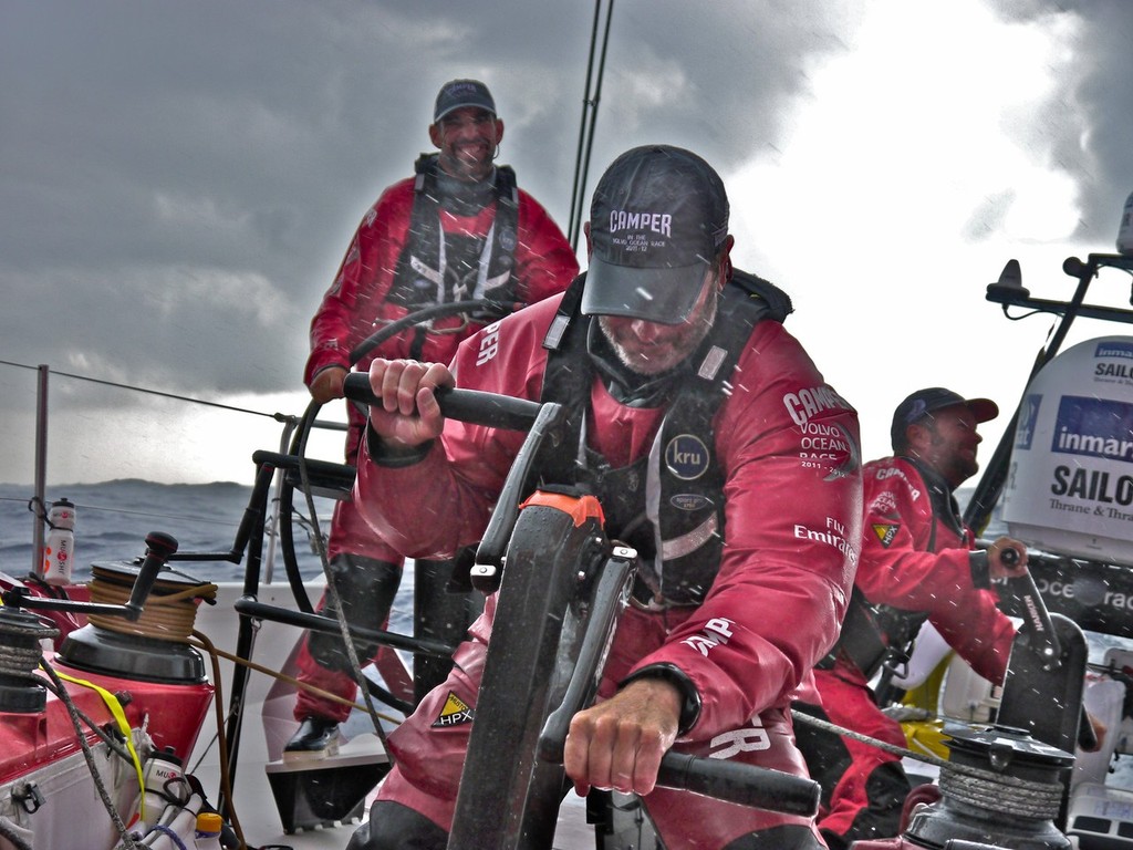 Rob Salthouse and Chris Nicholson grind hard as they put a reef in the mainsail as Stu Bannatyne drives onboard CAMPER with Emirates Team New Zealand during leg 3 of the Volvo Ocean Race 2011-12, from Abu Dhabi, UAE to Sanya, China. (Credit: Hamish Hooper/CAMPER ETNZ/Volvo Ocean Race) photo copyright Hamish Hooper/Camper ETNZ/Volvo Ocean Race taken at  and featuring the  class