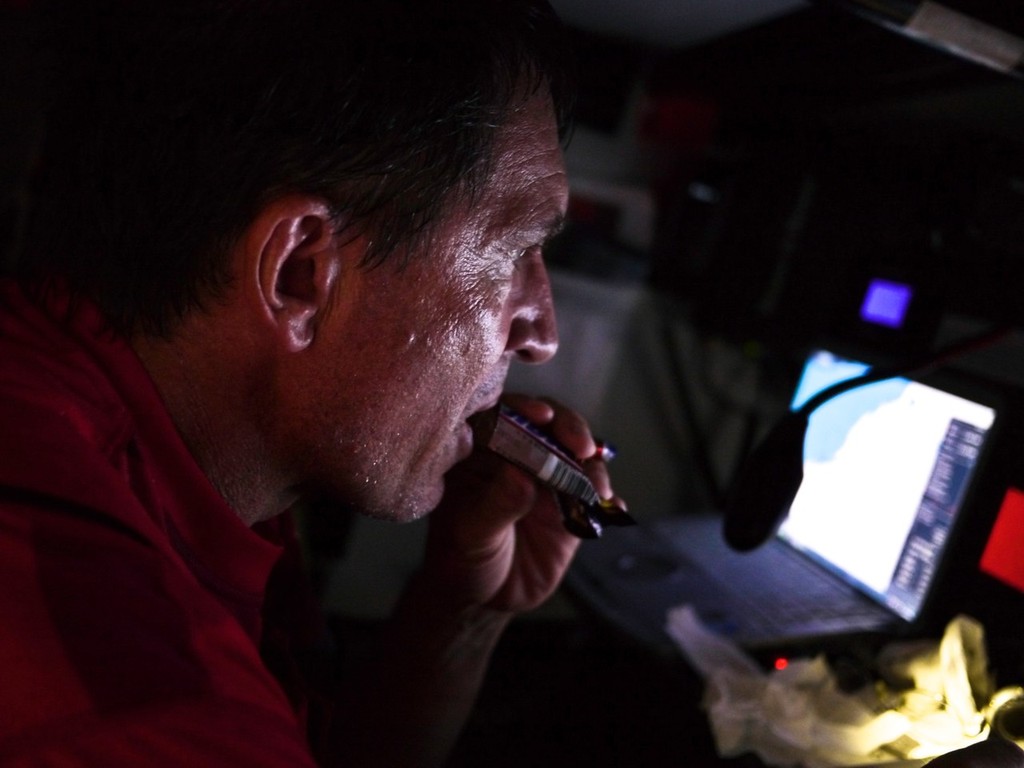 Navigator Will Oxley delves into some chocolate onboard CAMPER with Emirates Team New Zealand during leg 4 of the Volvo Ocean Race 2011-12, from Sanya, China to Auckland, New Zealand. photo copyright Hamish Hooper/Camper ETNZ/Volvo Ocean Race taken at  and featuring the  class